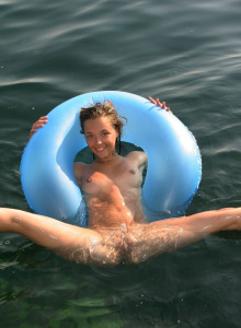 Nude Kalinka in the sea on the life-saver